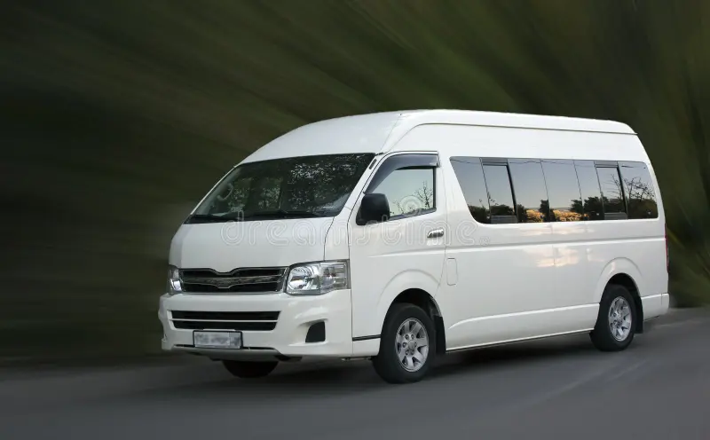toyota-hiace-white-minivan-toyota-hiace-white-minivan-motion-blurred-background-159162355